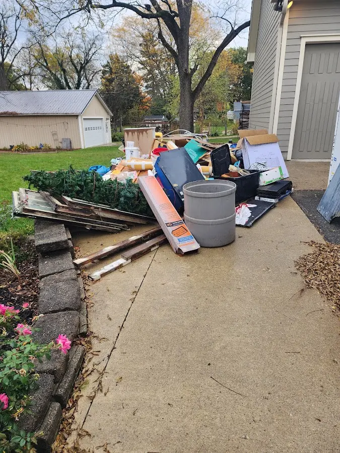 Dumpster being loaded with debris for Estate Cleanout Dumpster Rental in Copperopolis